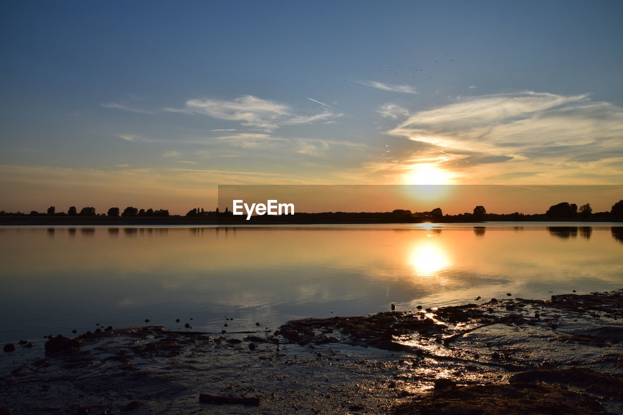 Scenic view of lake against sky during sunset