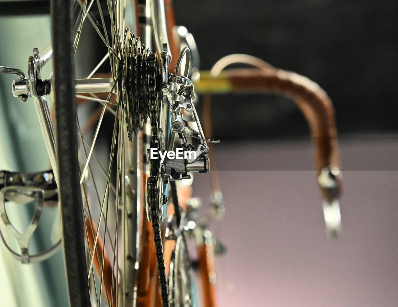 bicycle, vehicle, sports equipment, land vehicle, road bicycle, no people, close-up, focus on foreground, metal, wheel, indoors, transportation, selective focus, iron