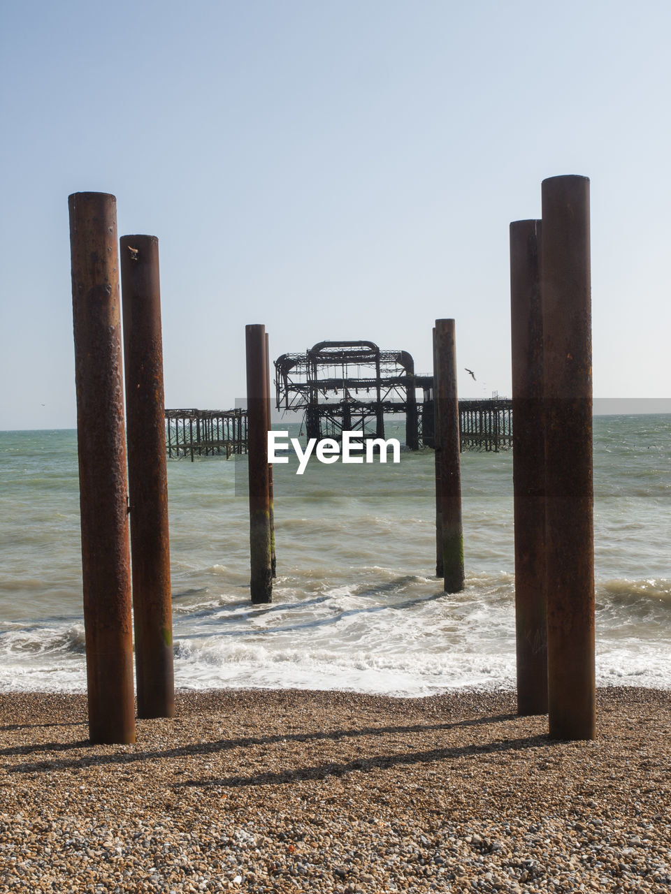 Pier on calm sea against clear sky
