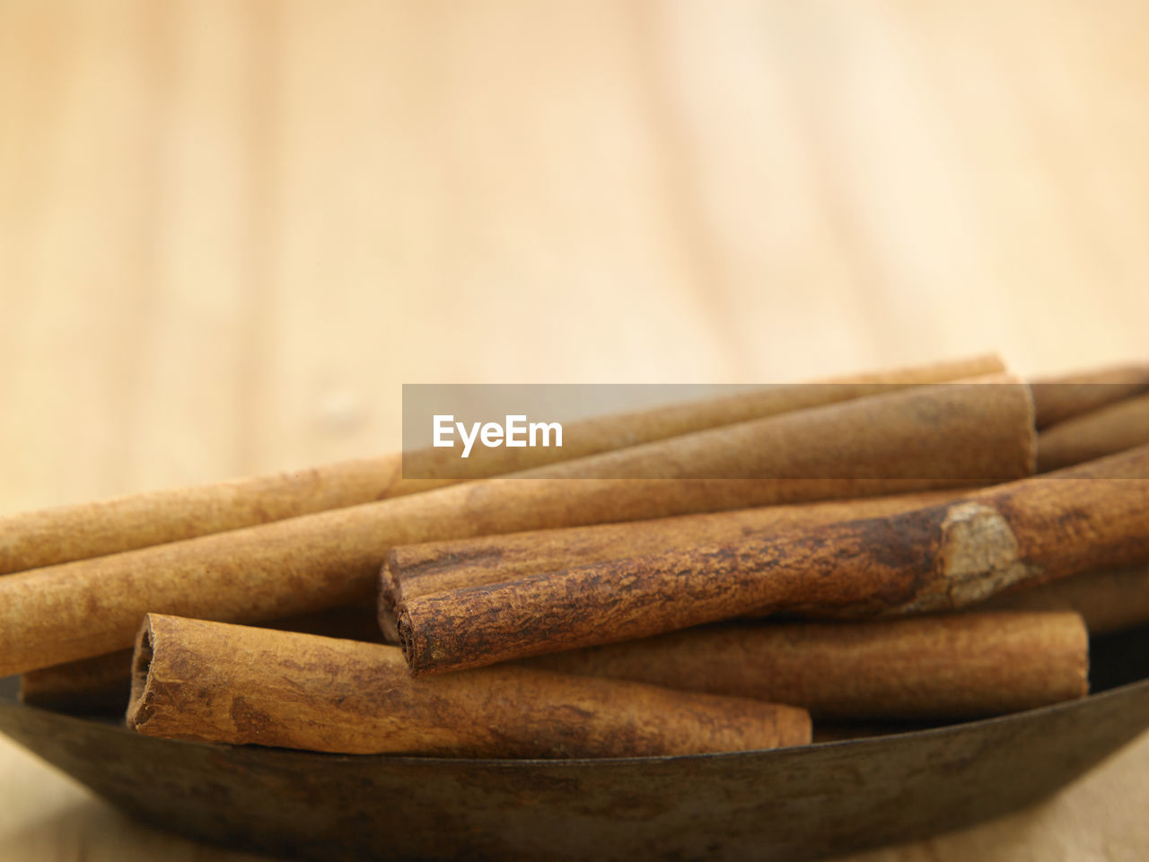 Close-up of cinnamons in bowl on table