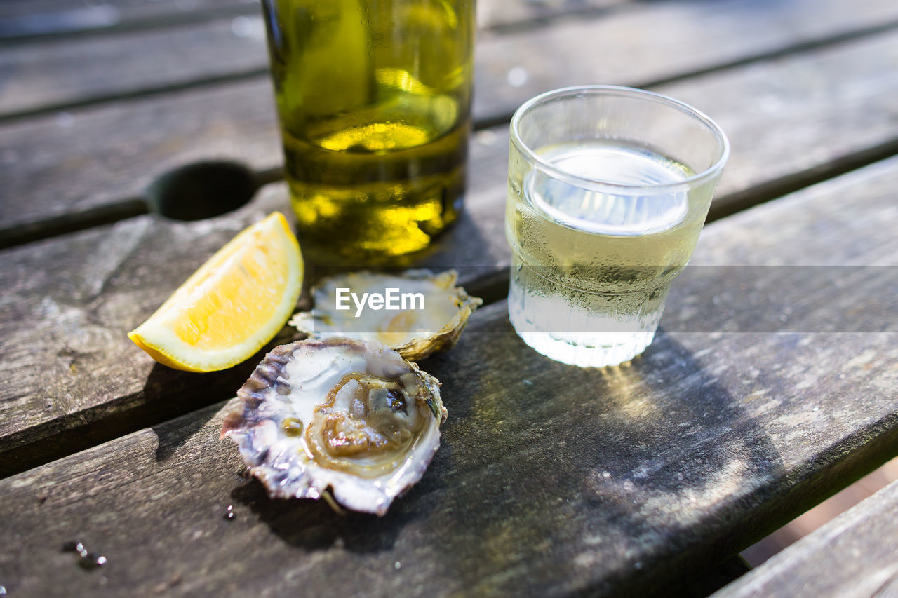 Close-up of drink and oyster on table