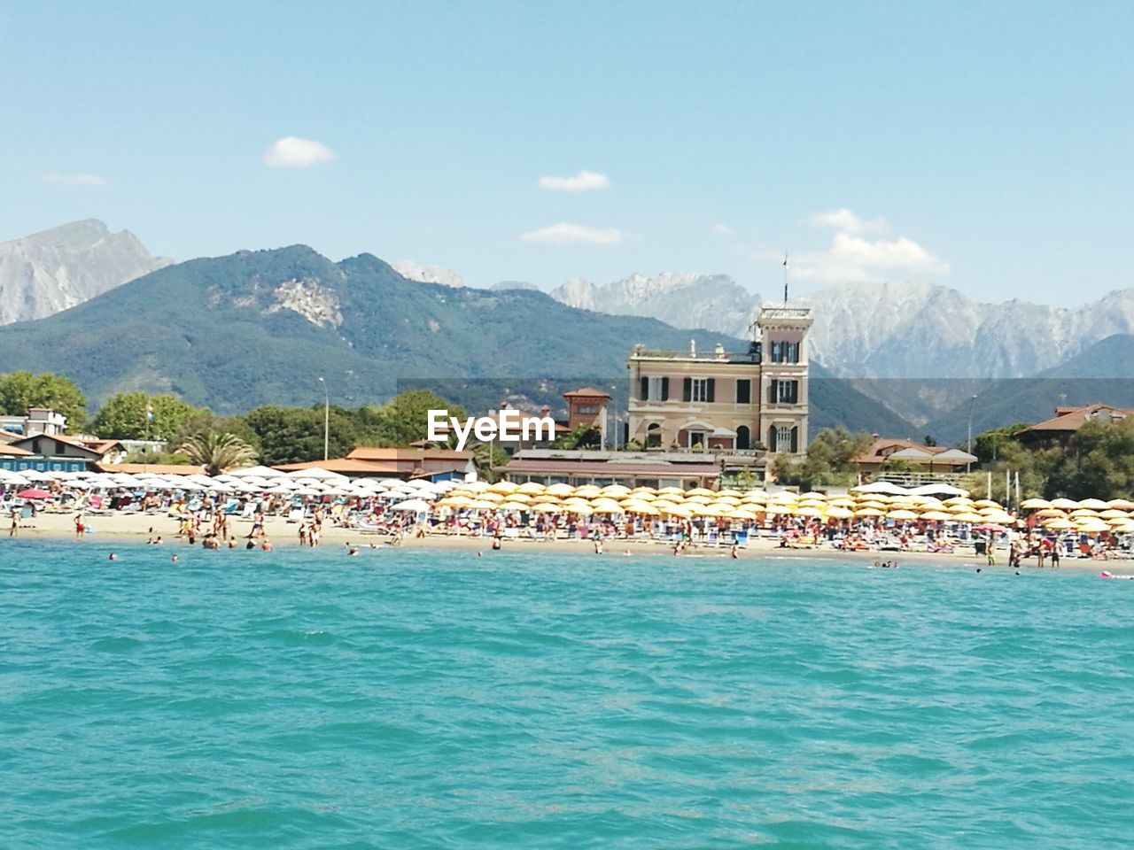 VIEW OF SEA WITH HOUSES IN BACKGROUND