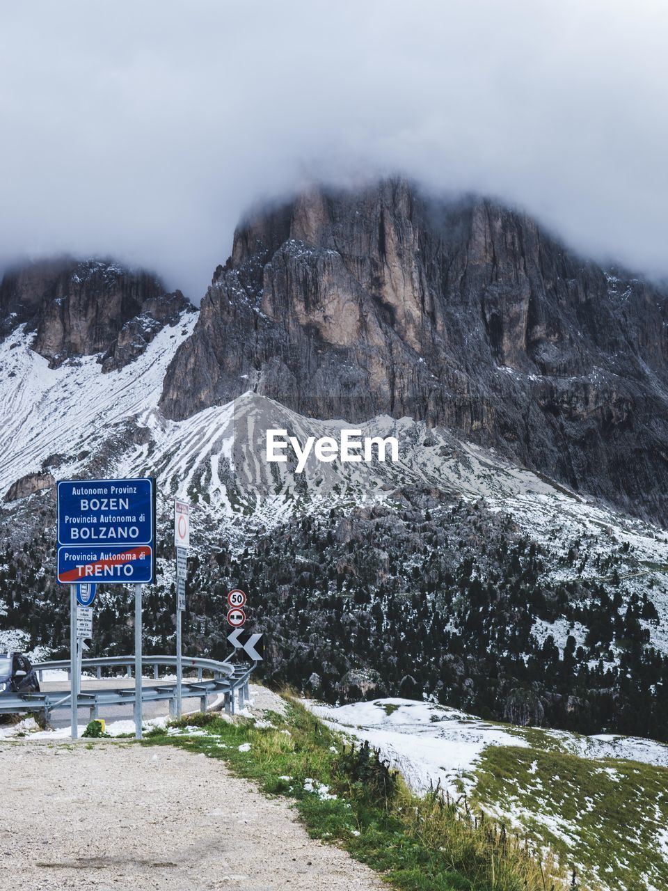 SNOW COVERED ROAD BY MOUNTAIN
