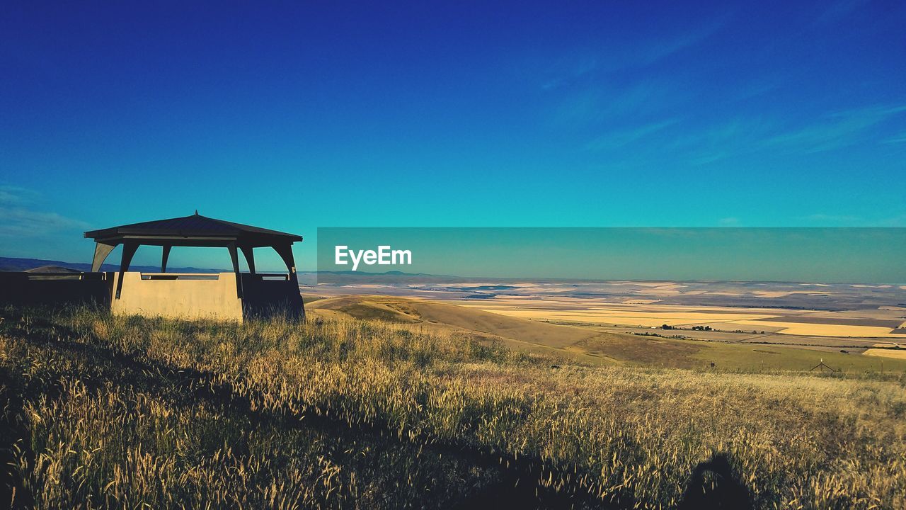 SCENIC VIEW OF BEACH AGAINST BLUE SKY