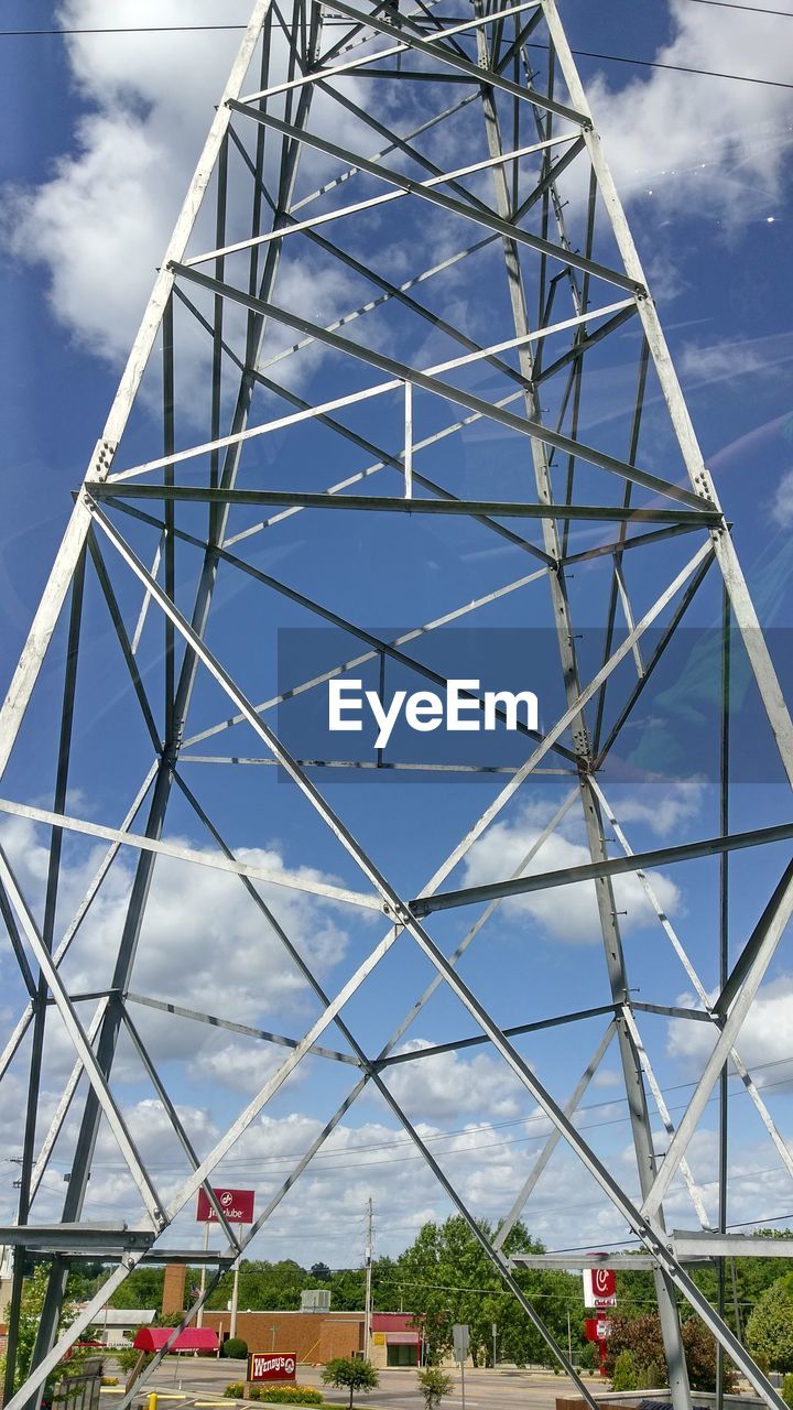 Low angle view of grid structure against blue sky