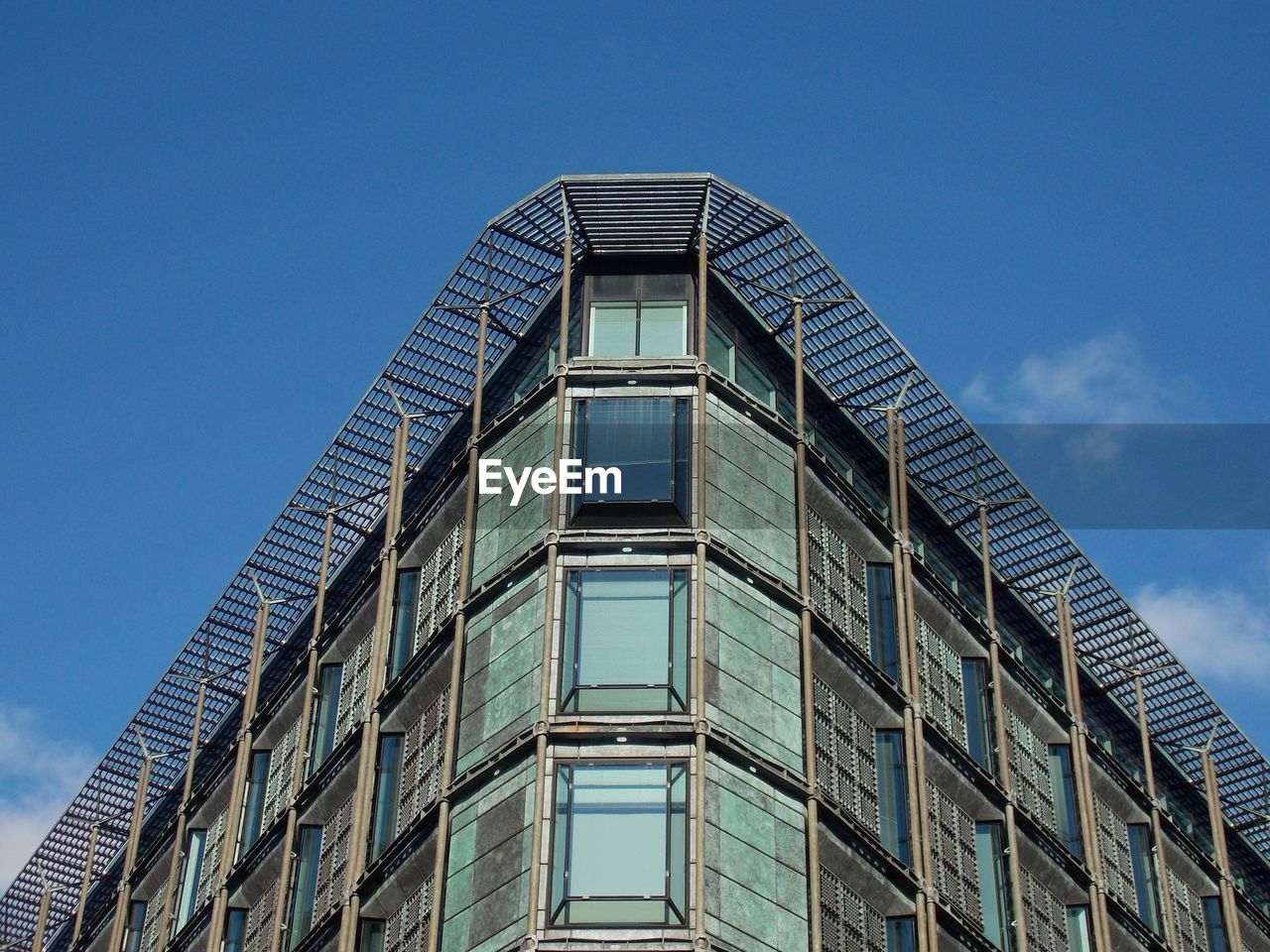 Low angle view of modern building against clear blue sky