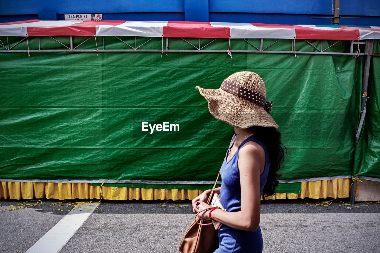 Side view of woman walking on street