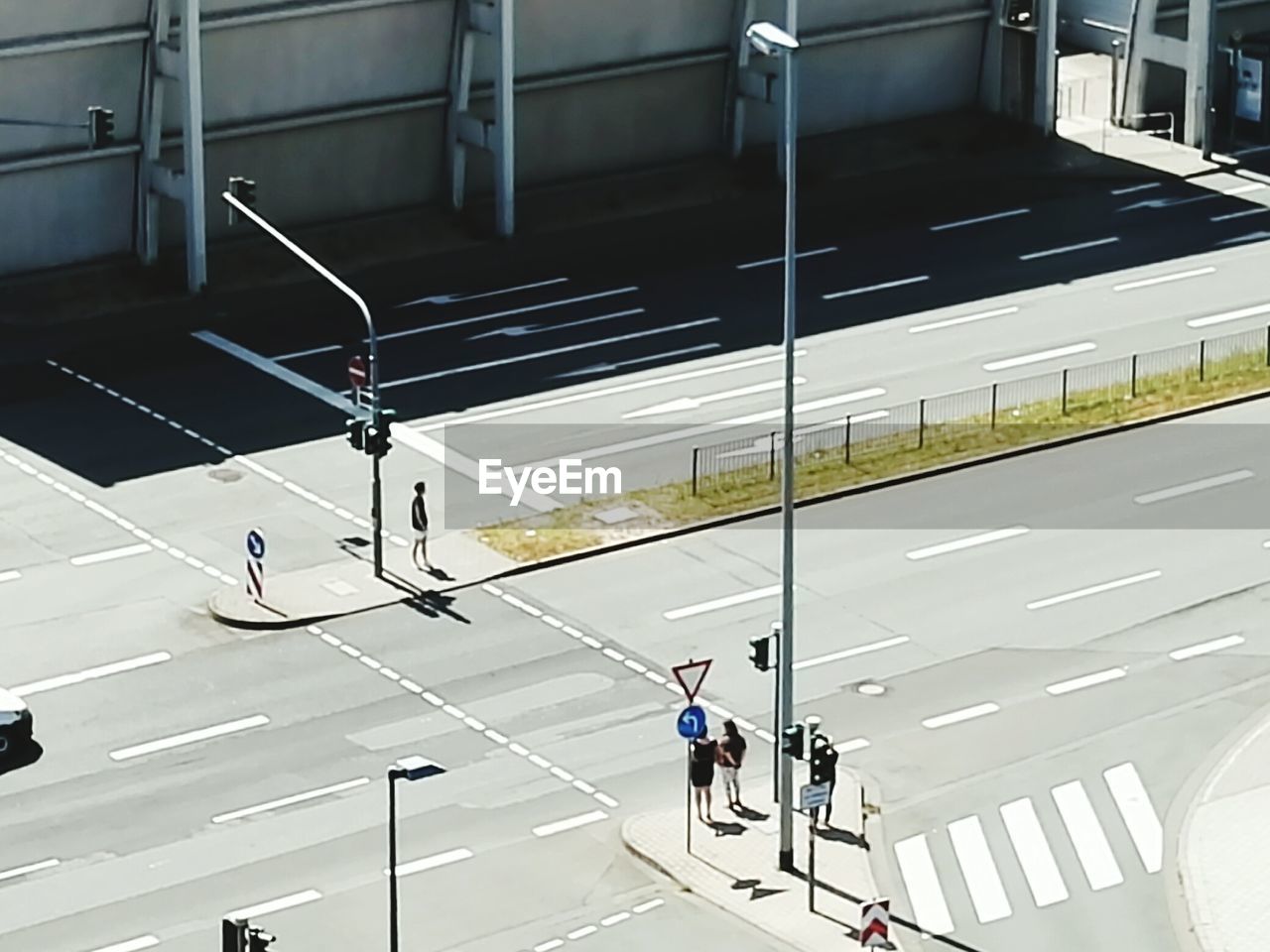 HIGH ANGLE VIEW OF PEOPLE WALKING ON ROAD
