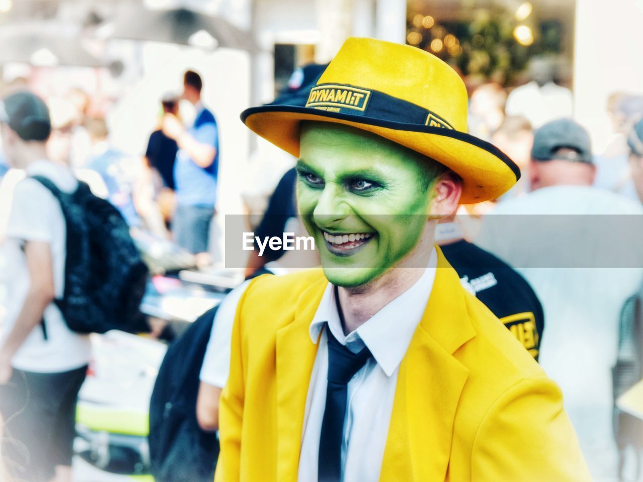 PORTRAIT OF SMILING MAN STANDING AGAINST YELLOW
