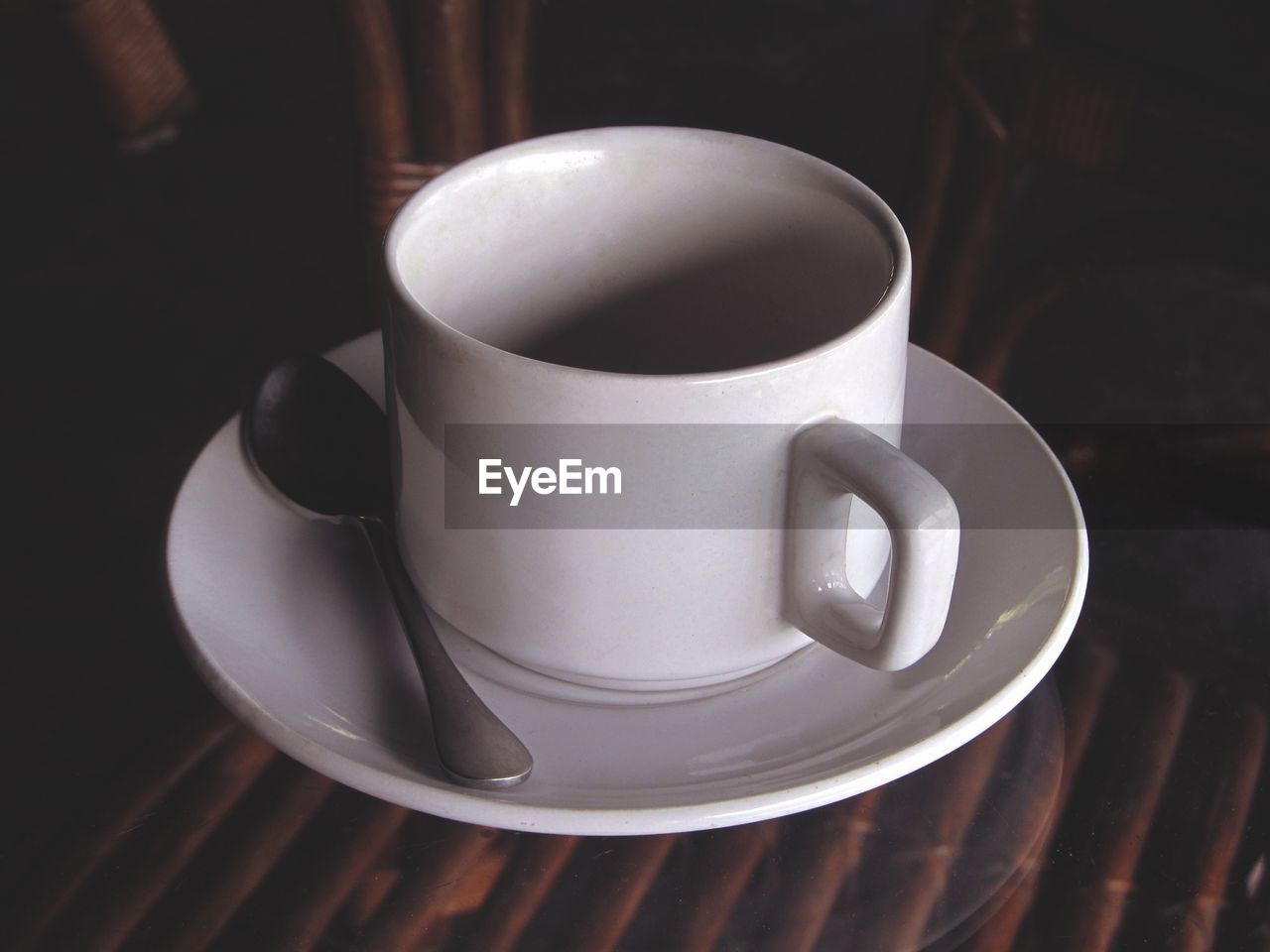 CLOSE-UP OF COFFEE CUP AND TABLE