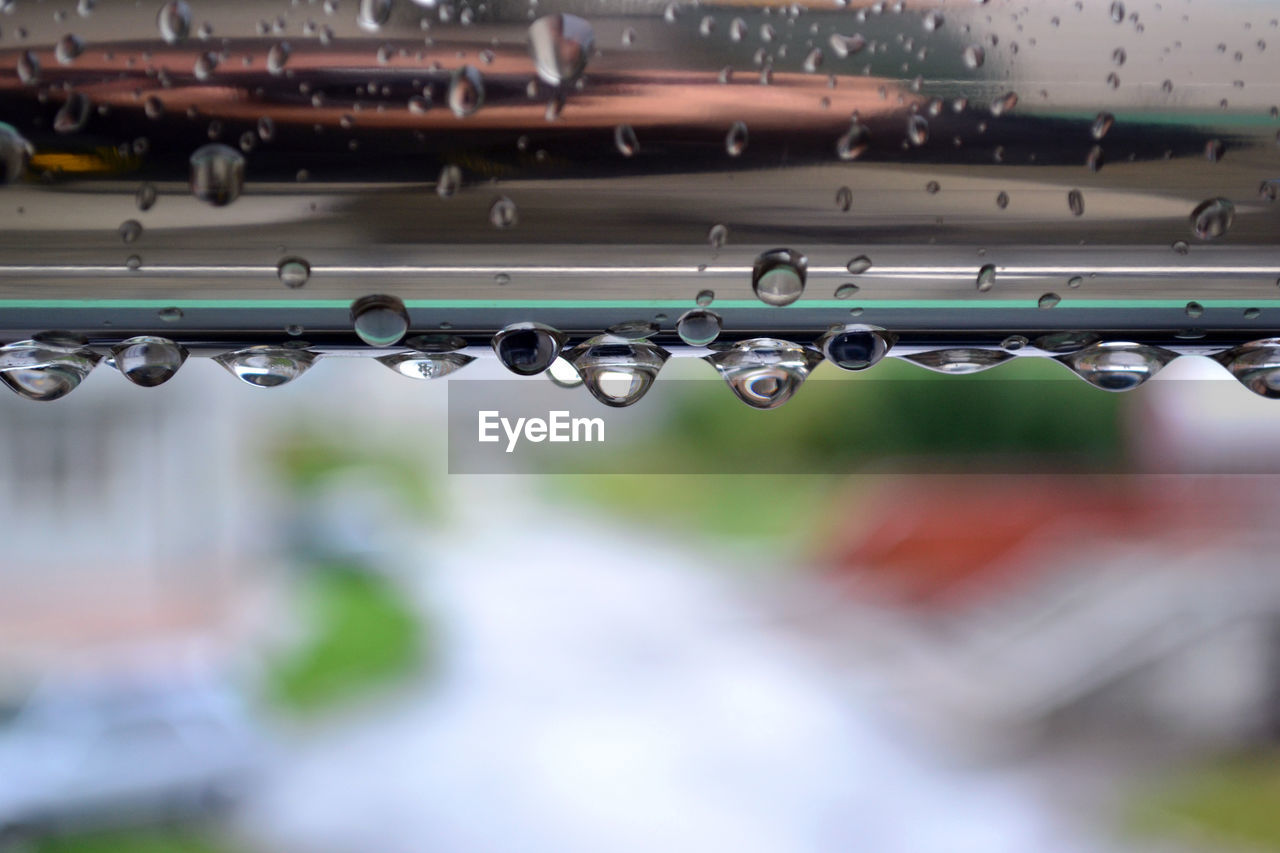 Low angle view of water drops on metallic structure