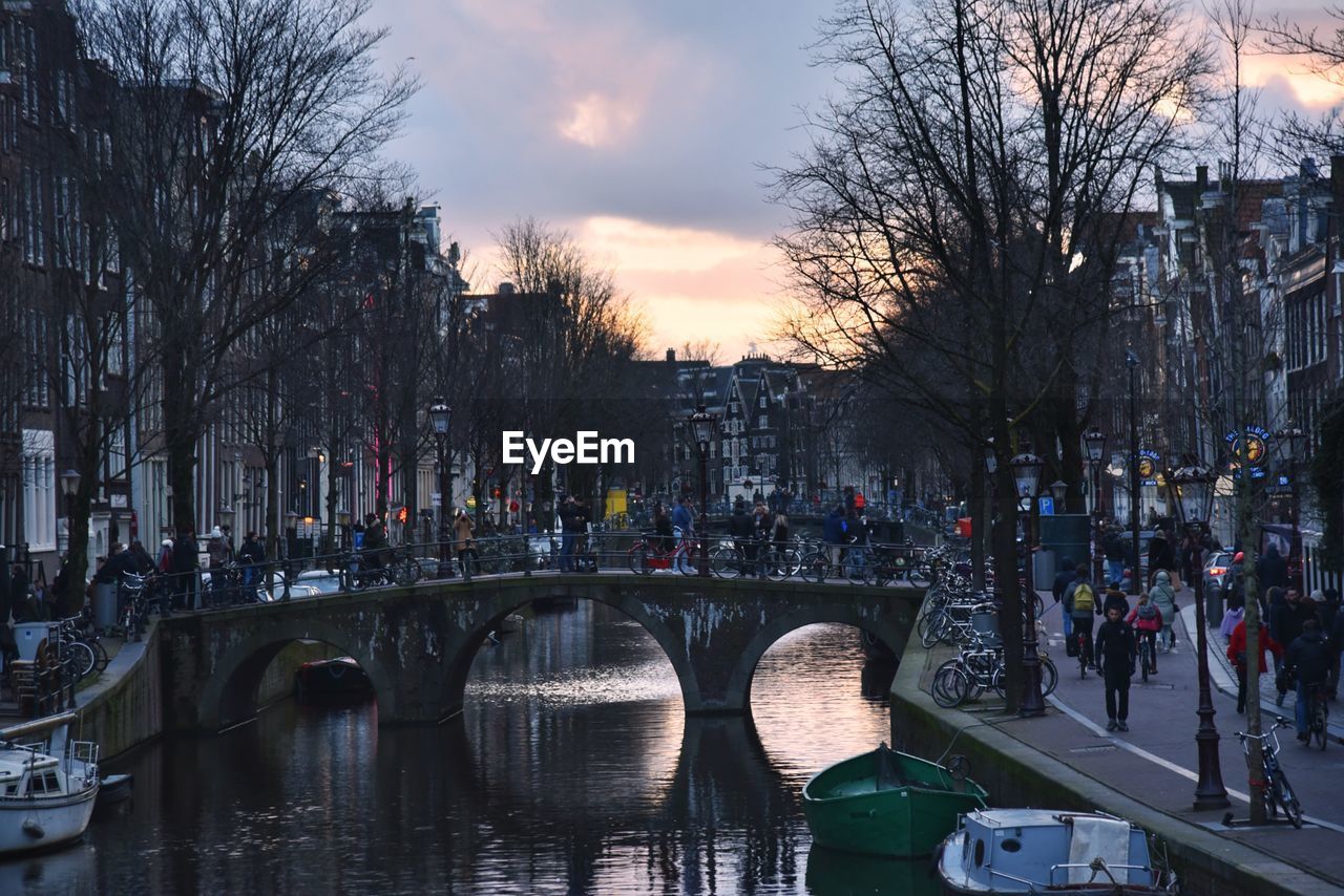 PANORAMIC VIEW OF PEOPLE ON BRIDGE OVER CANAL