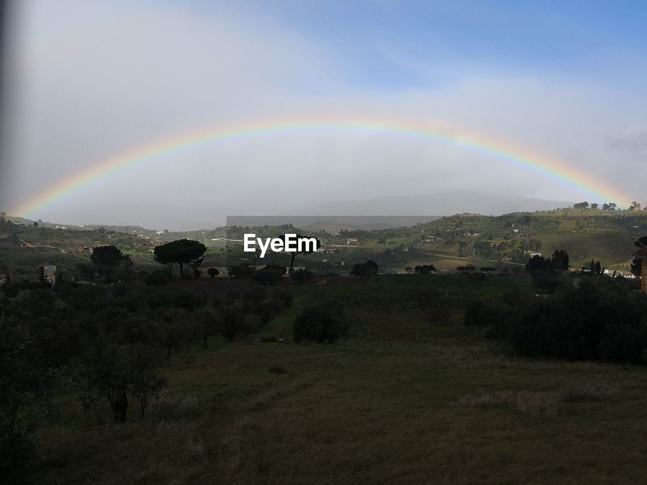 SCENIC VIEW OF RAINBOW AGAINST SKY DURING SUNSET