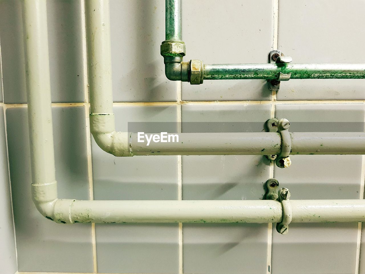 CLOSE-UP OF PIPES AGAINST WALL
