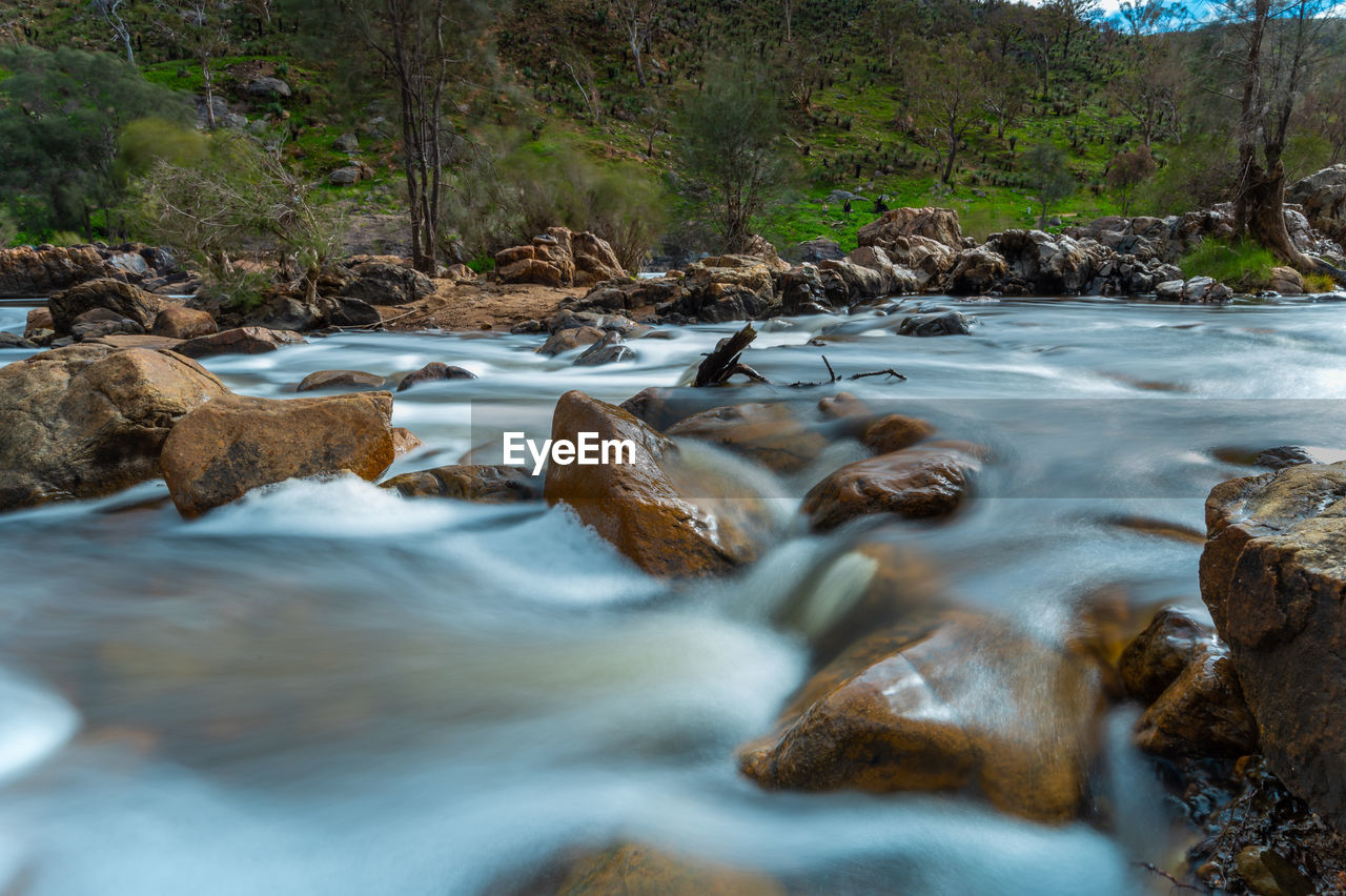 SURFACE LEVEL OF STREAM FLOWING THROUGH ROCKS