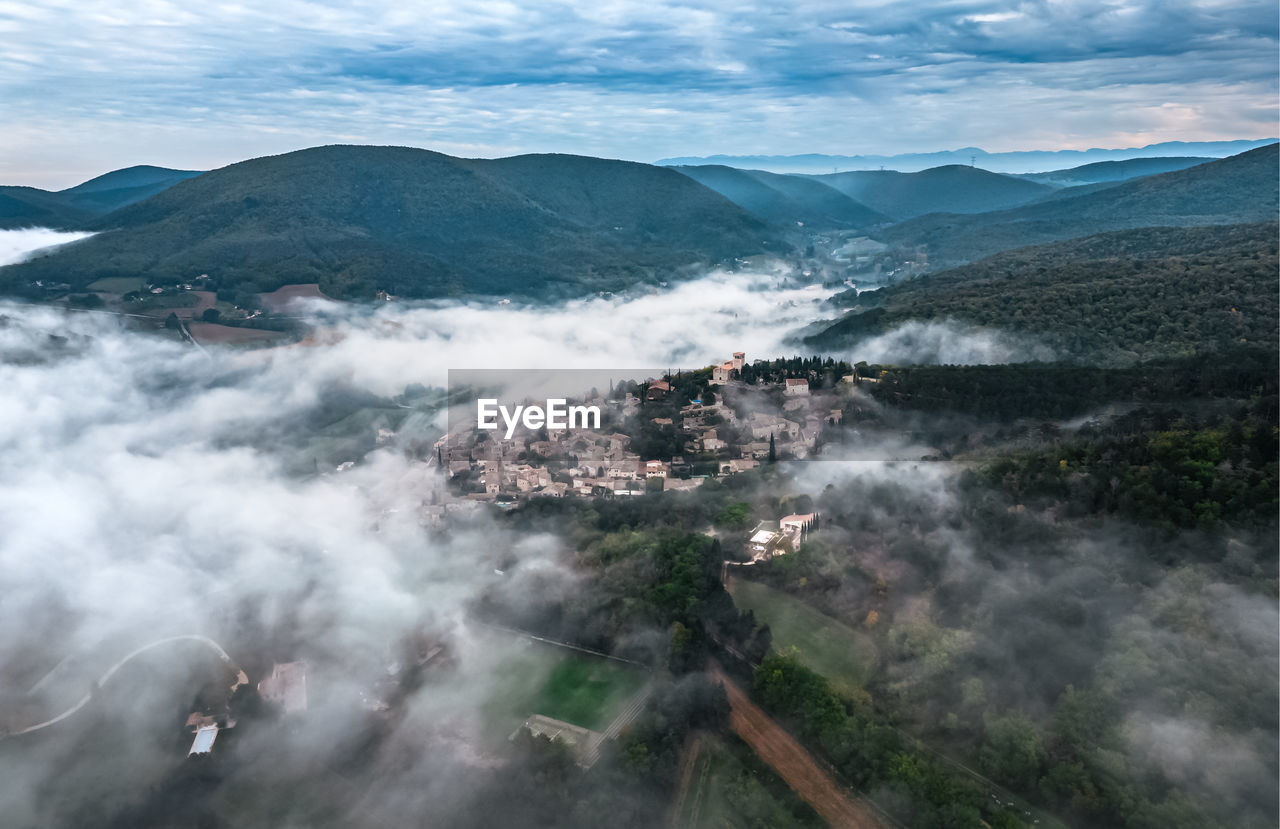 Panoramic view of the old village of mirmande. aerial photo in the morning in the thick fog rising 