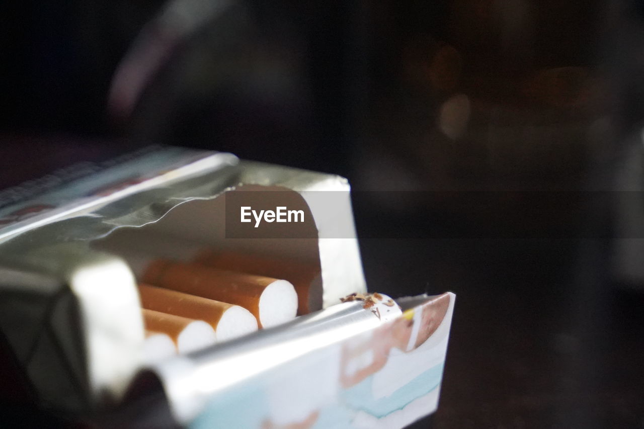 CLOSE-UP OF CIGARETTE ON TABLE WITH TEXT