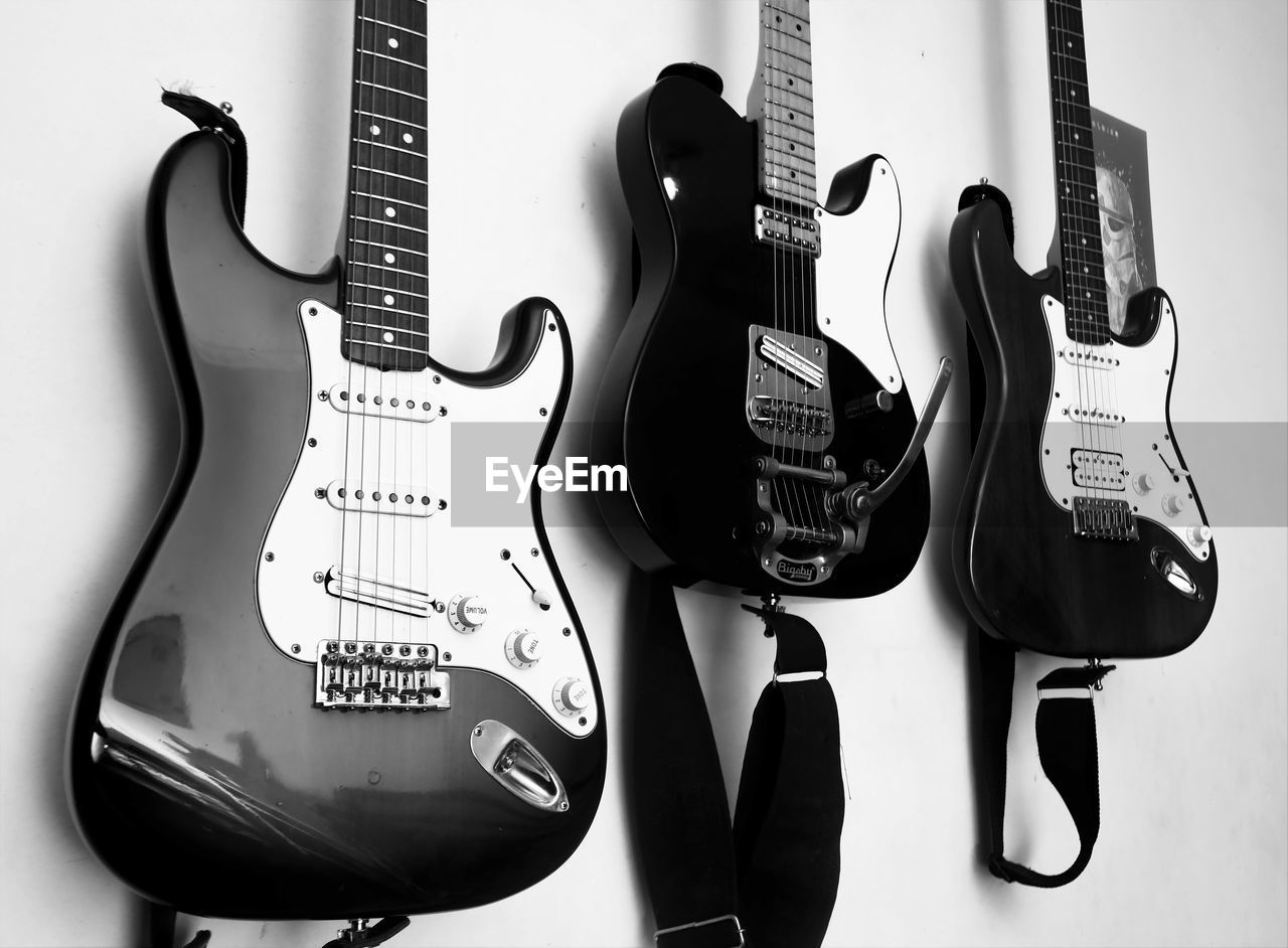 guitar, musical instrument, string instrument, music, musical equipment, electric guitar, black and white, arts culture and entertainment, bass guitar, monochrome, black, monochrome photography, plucked string instruments, acoustic guitar, rock music, musician, font, acoustic-electric guitar, indoors, musical instrument string, string, modern rock