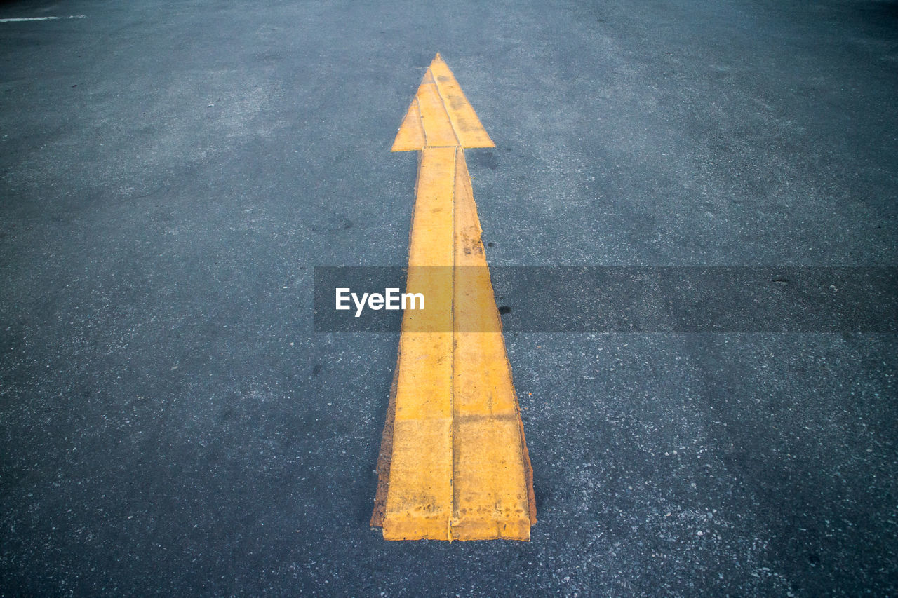 Yellow arrow symbol on road