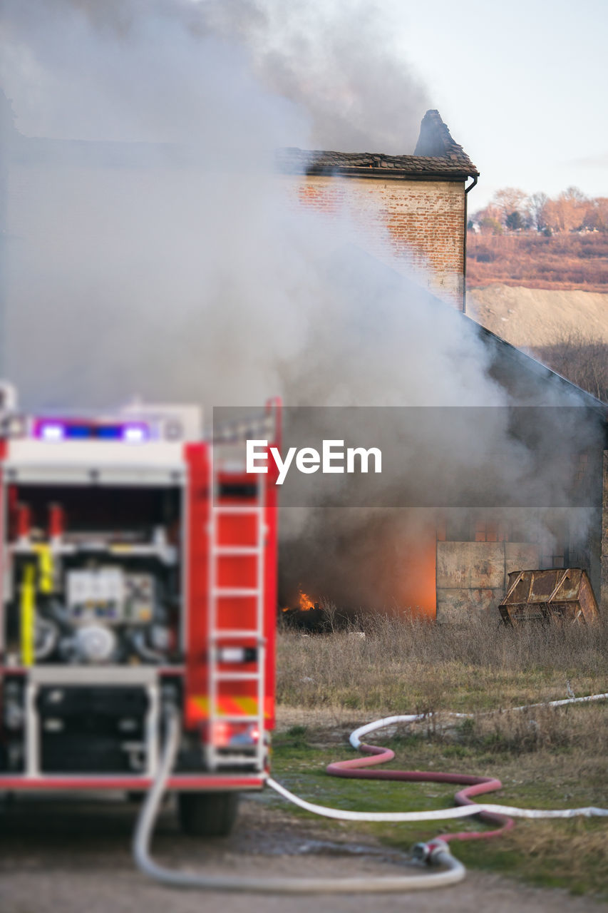 Fire truck against burning house