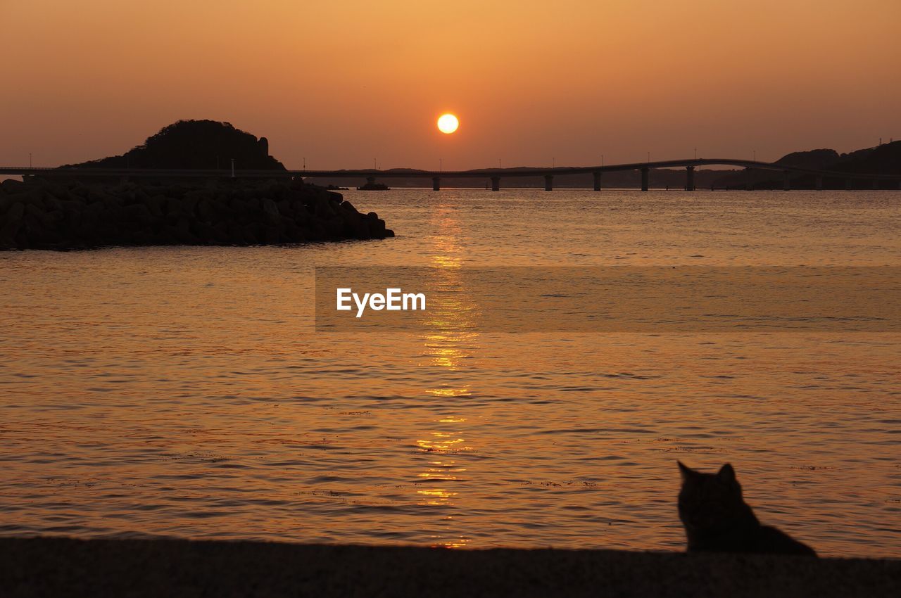 SCENIC VIEW OF SEA AGAINST ORANGE SKY