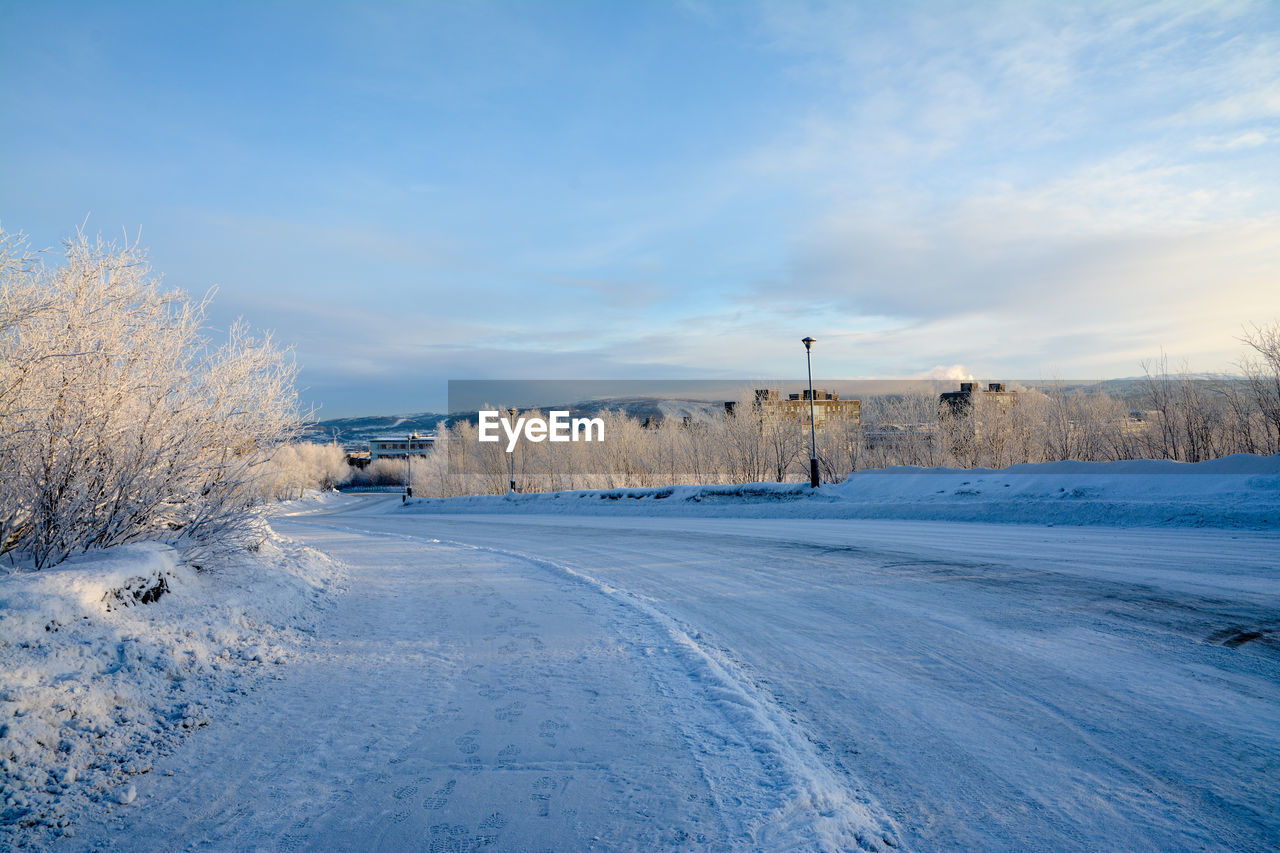 Snow covered landscape against sky