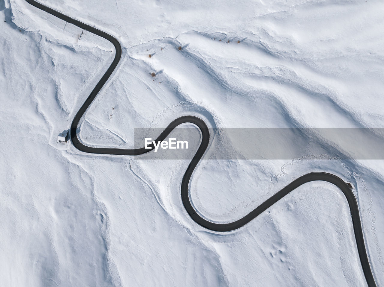 Aerial view of winding road from above at dolomities,italy. snake road from above in winter season