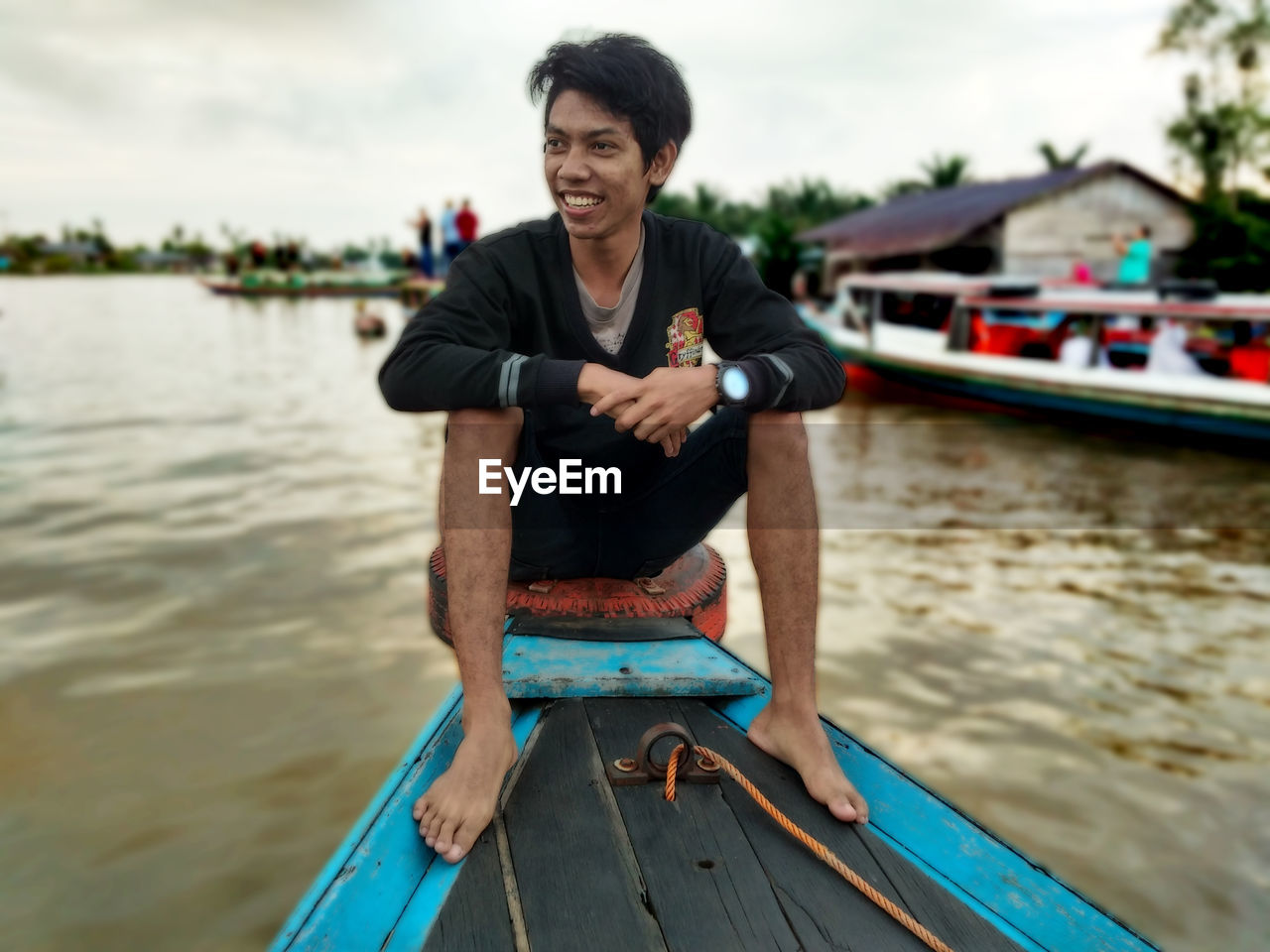 PORTRAIT OF SMILING MAN IN LAKE