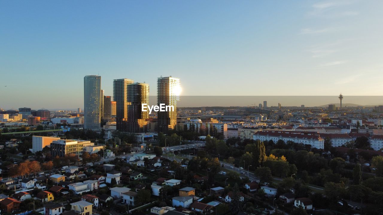 AERIAL VIEW OF MODERN BUILDINGS AGAINST SKY IN CITY