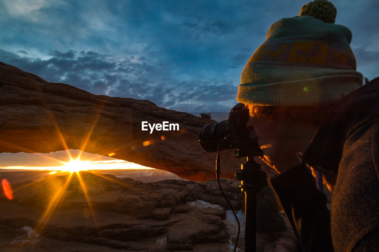 Man photographing at sunset