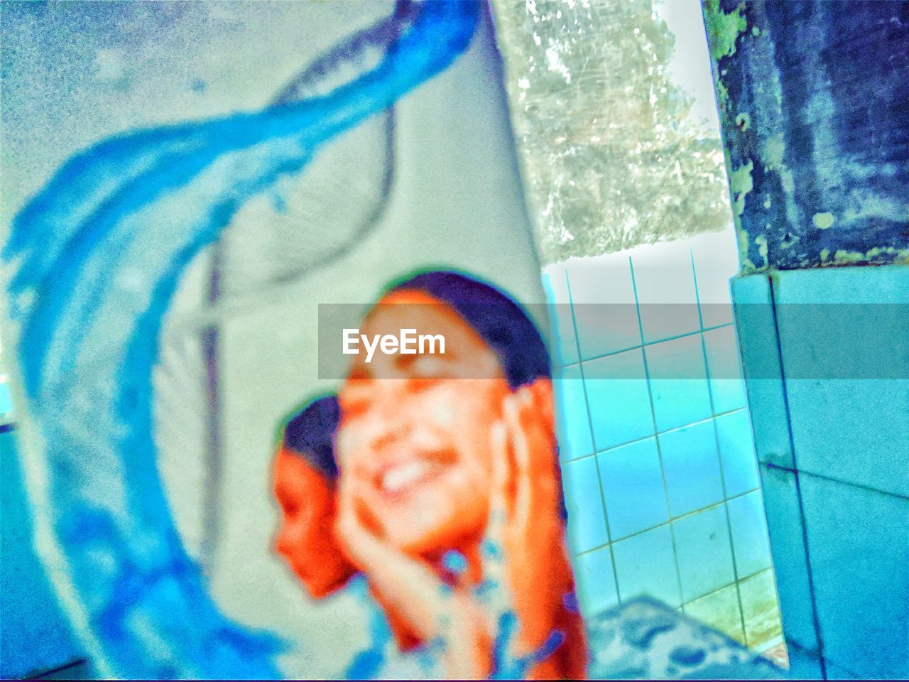 PORTRAIT OF BOY HOLDING A SWIMMING POOL