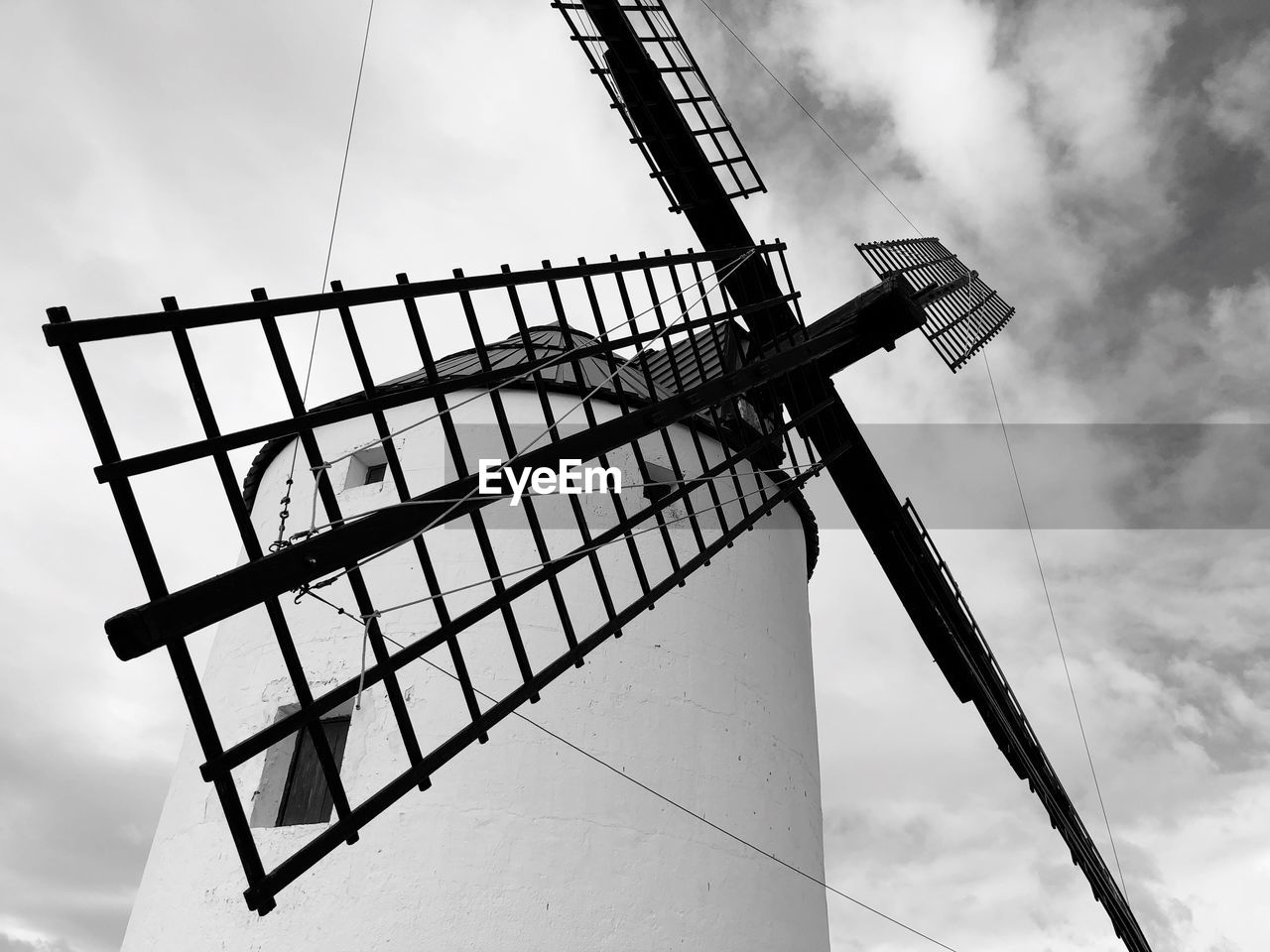 Low angle view of traditional windmill against sky