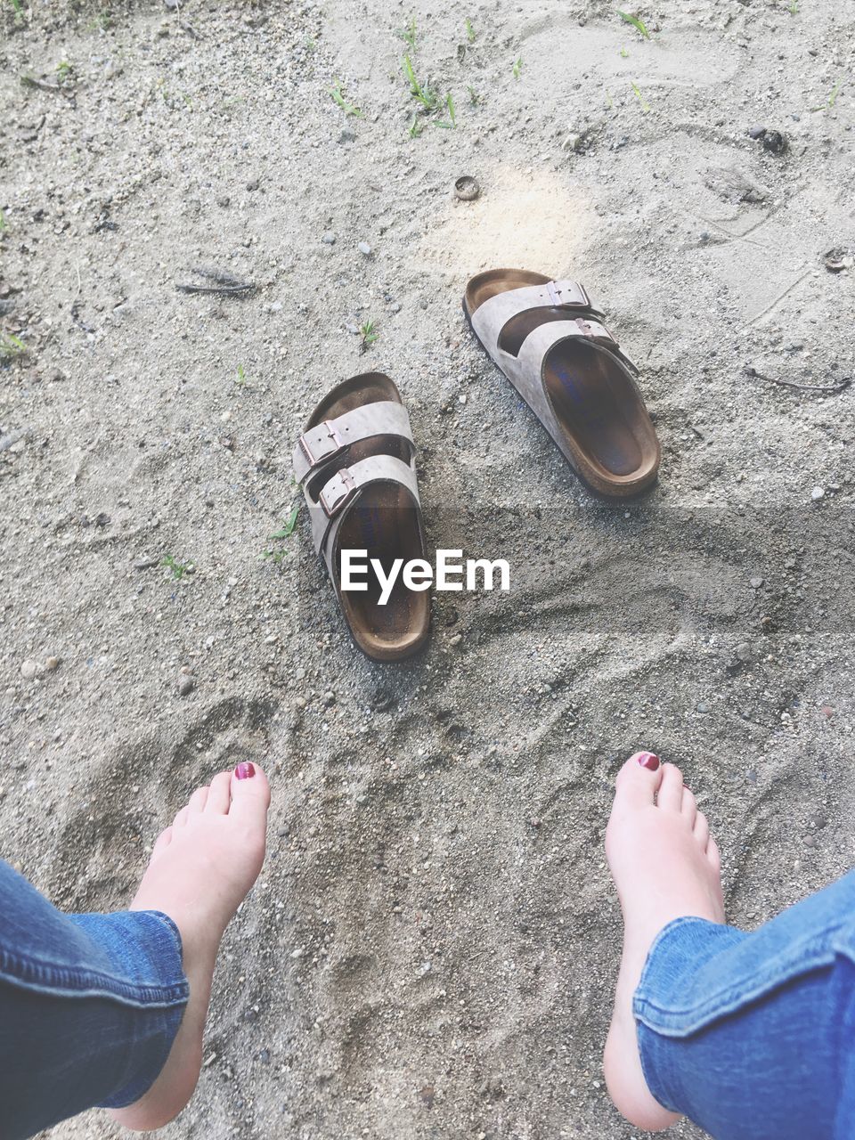 Low section of woman on sand