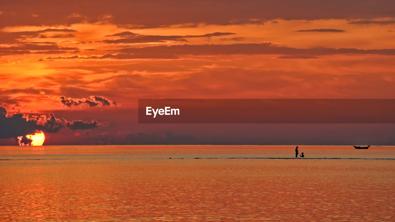 sky, water, sunset, sea, beauty in nature, cloud, scenics - nature, nature, orange color, beach, tranquility, land, tranquil scene, horizon, dawn, afterglow, idyllic, horizon over water, evening, reflection, holiday, travel destinations, vacation, outdoors, dramatic sky, trip, silhouette, travel, ocean, environment, sun, seascape, non-urban scene, tourism, sunlight, nautical vessel, no people