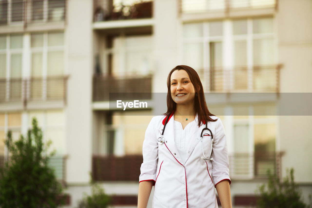 Portrait of doctor standing outdoors