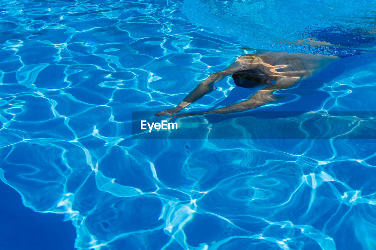 High angle view of man swimming in pool