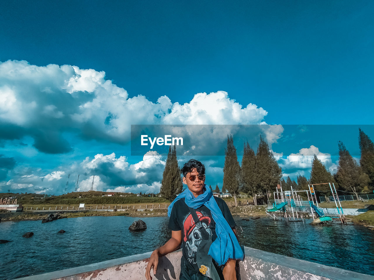 PORTRAIT OF YOUNG MAN AGAINST SKY