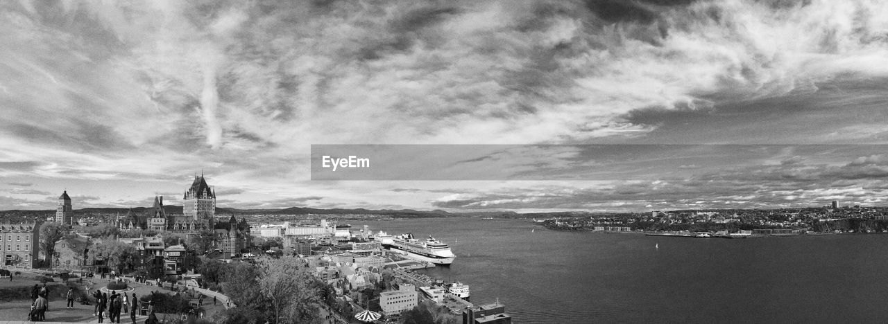 Panoramic view of city against cloudy sky