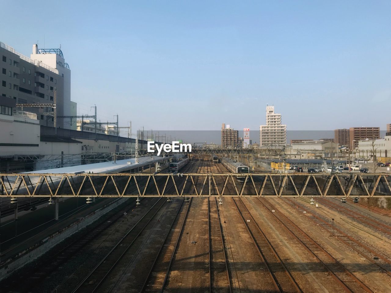 Railroad tracks amidst buildings in city against sky