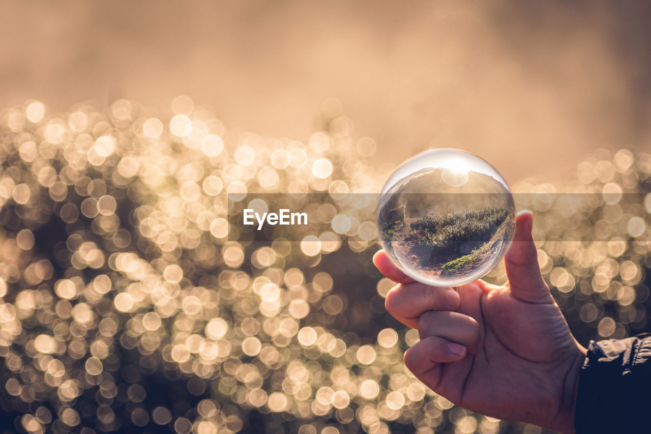 Close-up of person holding crystal ball