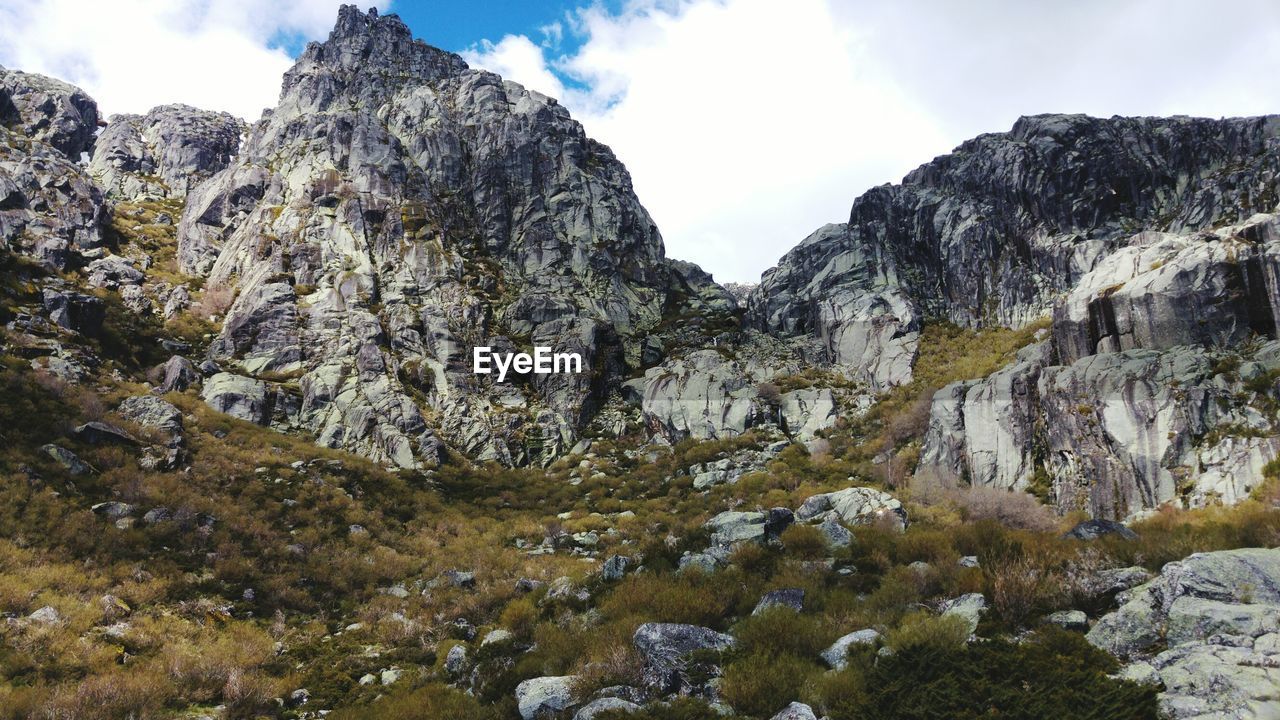 Scenic view of mountain rocks against sky