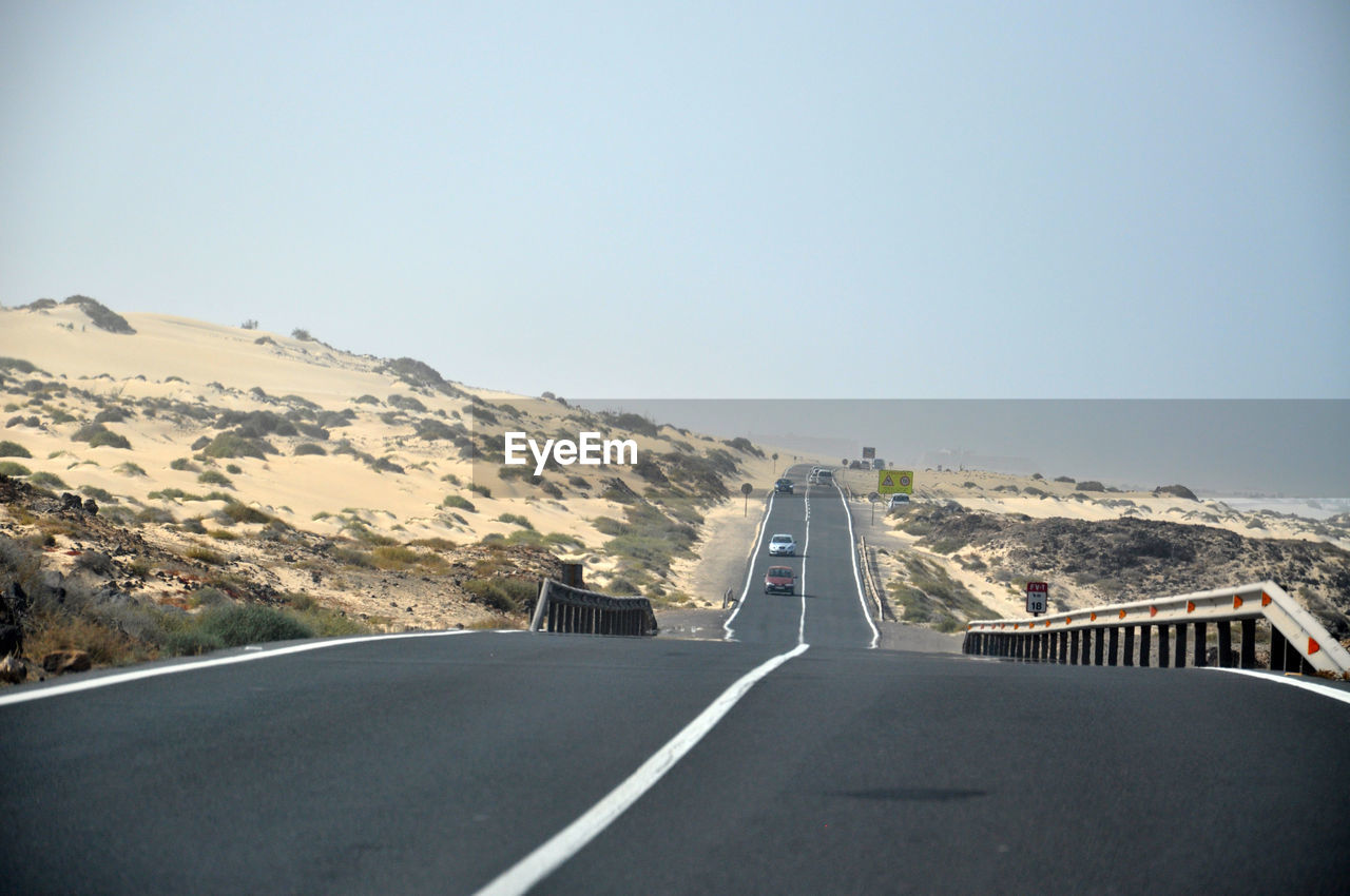 Highway in city against clear sky