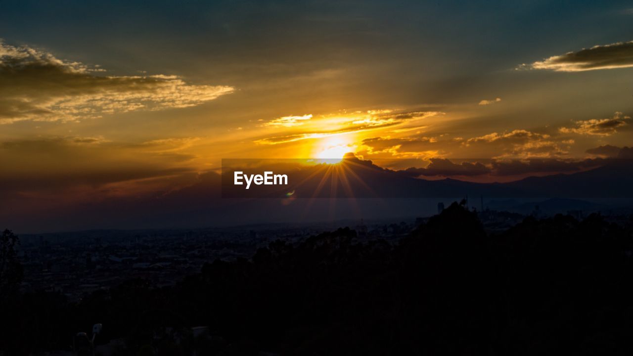 SCENIC VIEW OF SUNSET SKY OVER MOUNTAINS