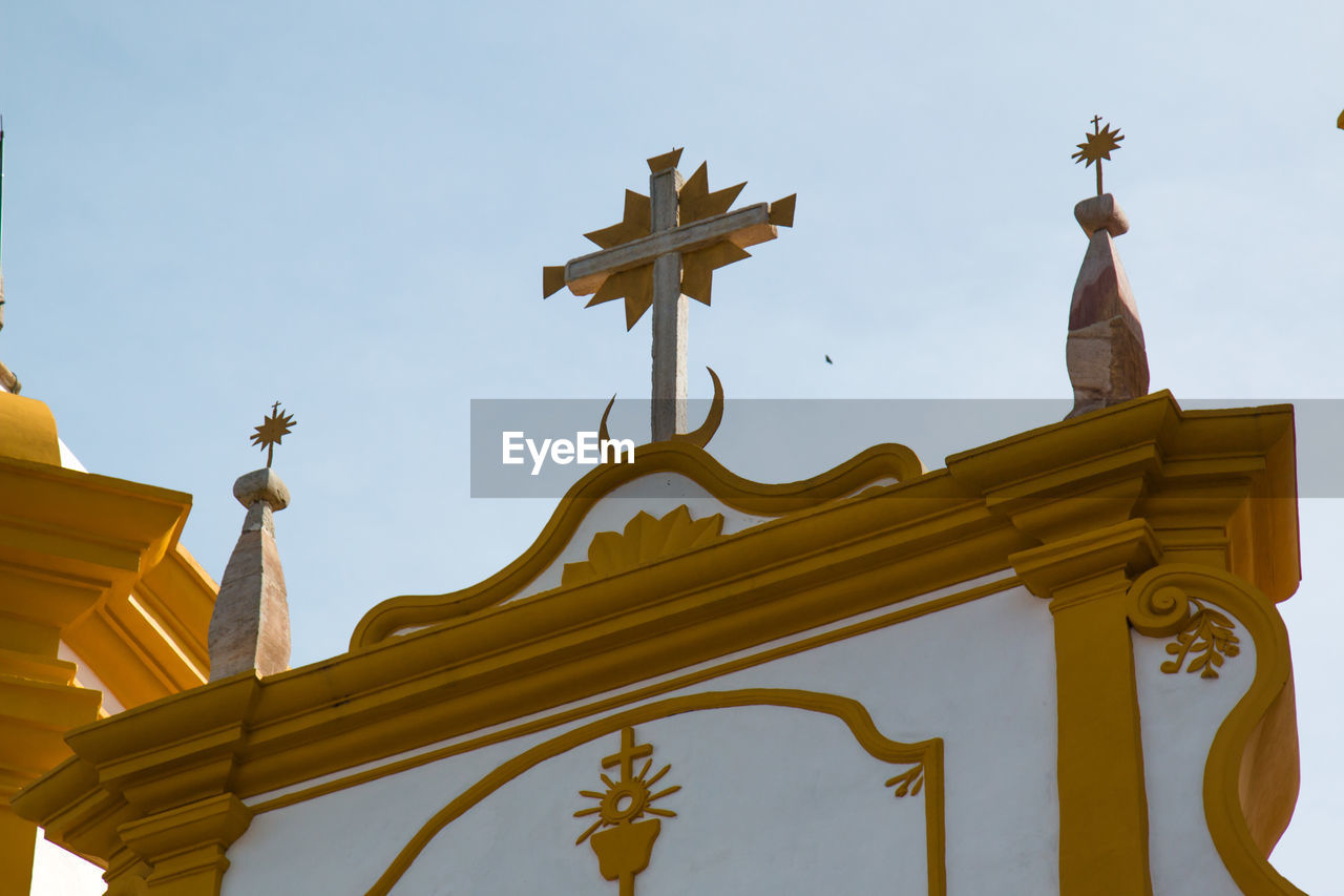 Low angle view of cross on igreja matriz church against sky