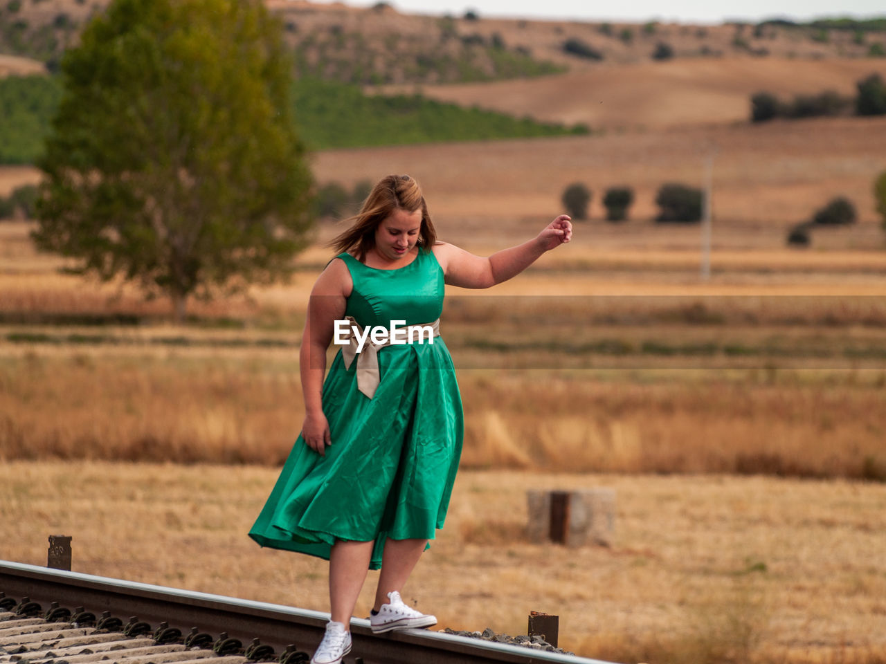 Woman standing on railroad tracks
