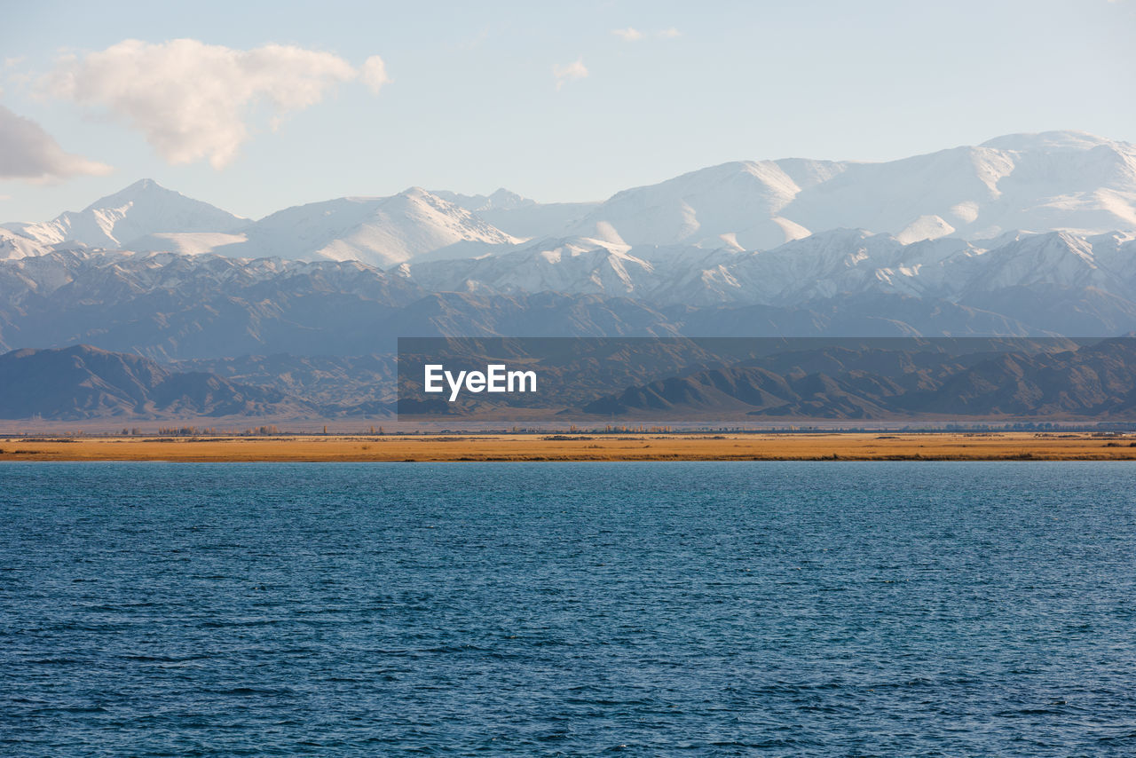 scenic view of lake and mountains against sky