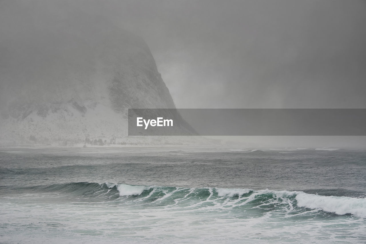 SCENIC VIEW OF SEA AND WAVES AGAINST SKY