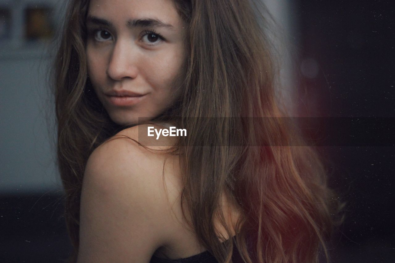 Close-up portrait of young woman with long hair