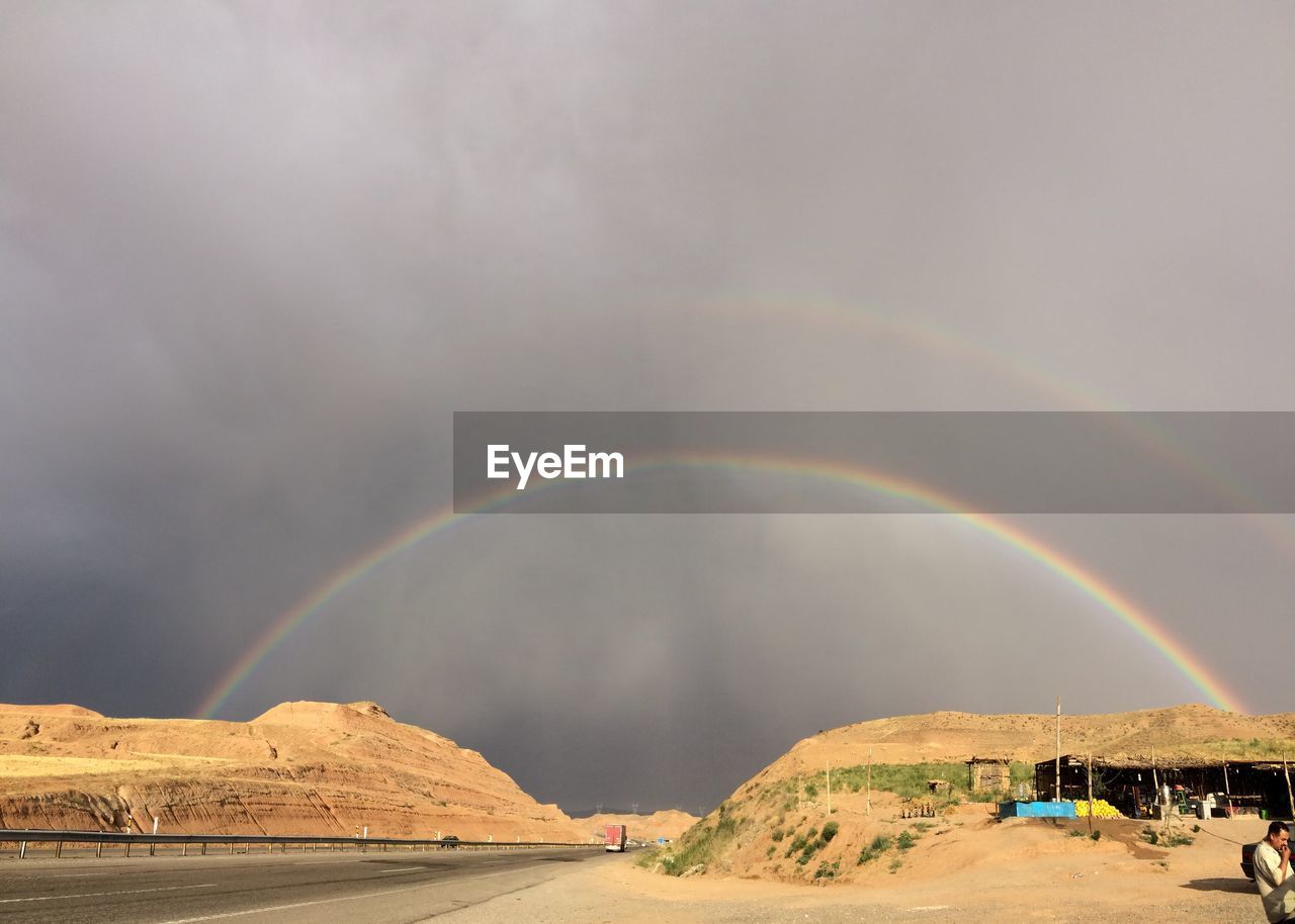 Scenic view of rainbow over landscape