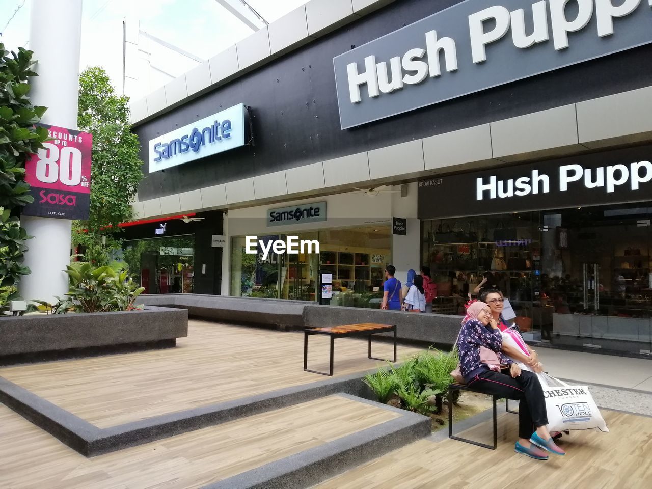 WOMAN SITTING ON A SIGN